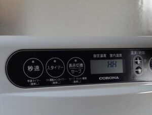 コロナ製ファンヒーターの液晶画面と操作パネル部。液晶にはHHと表示され使えない様子。