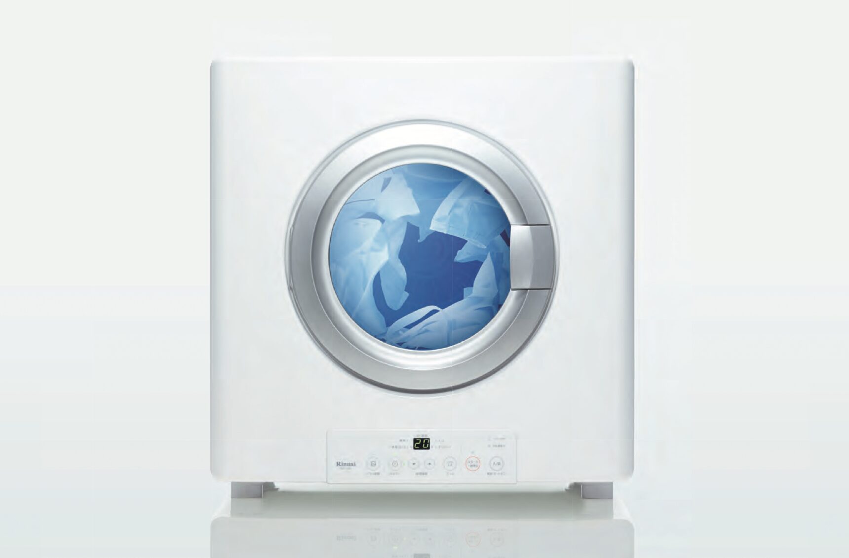 ガス衣類乾燥機の正面外観。丸い窓越しに衣類が見え、下部に操作パネルが付いたシンプルなデザイン。