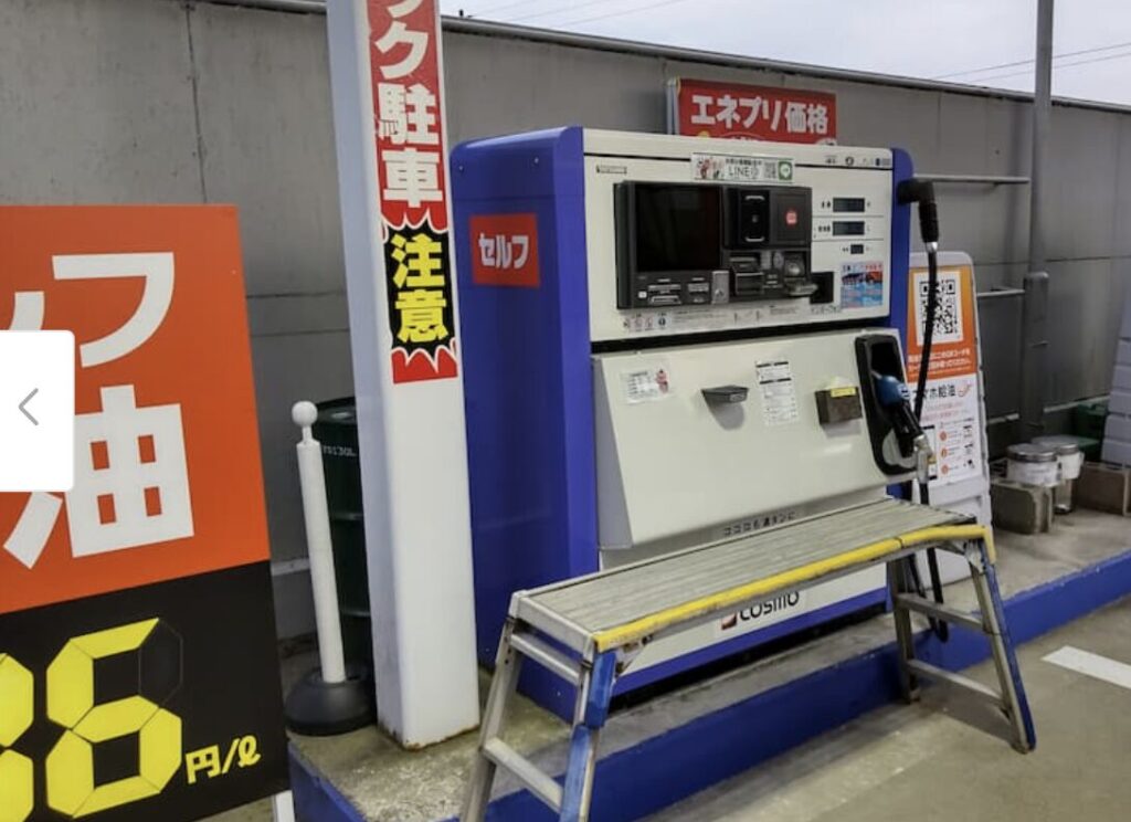 セルフ式の灯油給油機と価格表示看板が設置された灯油スタンドの様子。