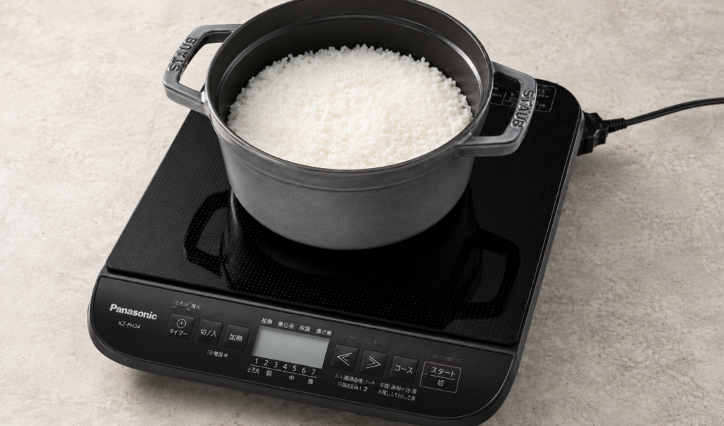 IHコンロの上に鍋を置いてご飯を炊いている様子